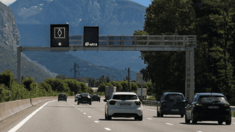 Carpool lane on the highway, indicated by a dedicated sign, reserved for vehicles carrying multiple occupants.